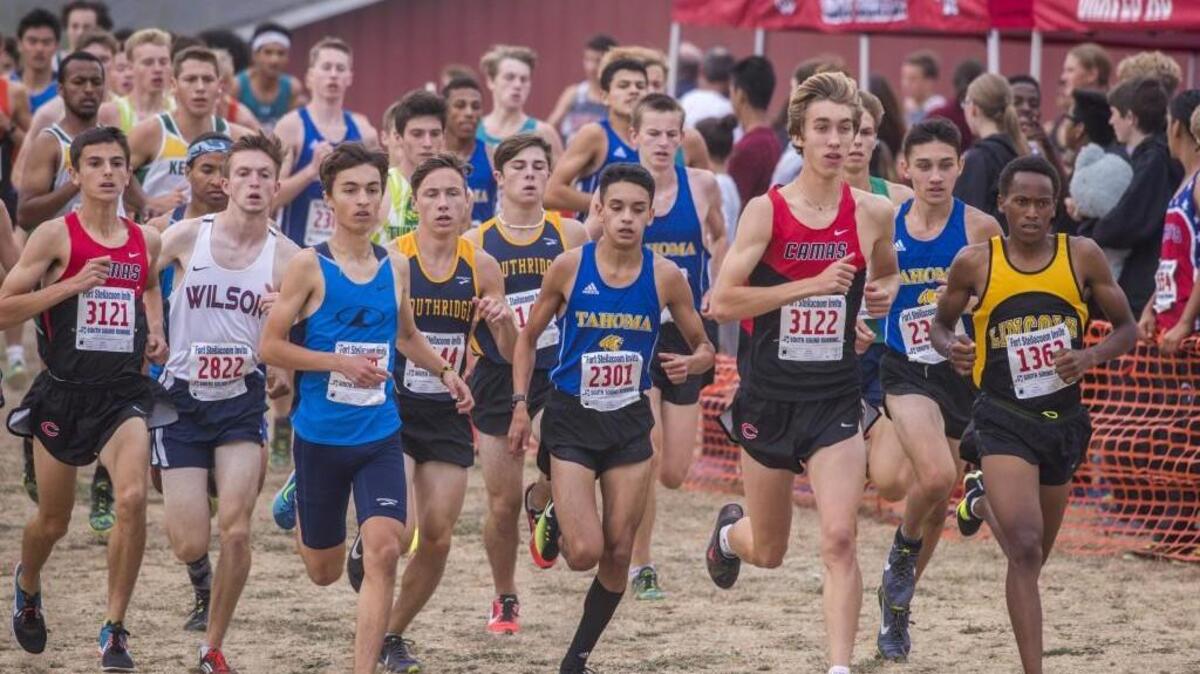 Bradley Peloquin of Gig Harbor (left, front) and James Mwaura of Lincoln High School (right) are at the front of the pack in the gold division boys 5000 meter run at the Fort Steilacoom Cross Country Invitational, with runners from schools all over the state, September 16, 2017. Mwaura won and Peloquin took second.