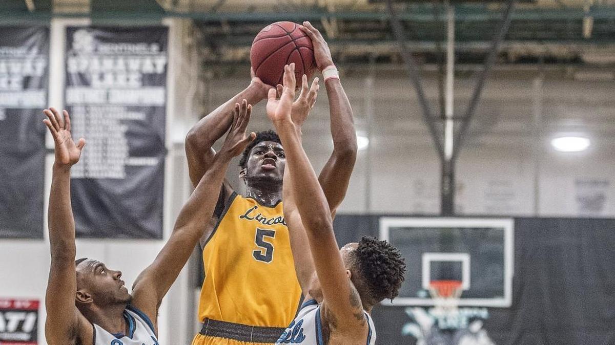 Lincoln forward Willie C Thomas iii (5) attempts a shot during Lincoln High School's thrilling 68-62 win against the Spanaway Lake Sentinels at Spanaway Lake Wednesday, Jan. 3, 2017. Winner takes over atop the 3A Pierce County League standings.