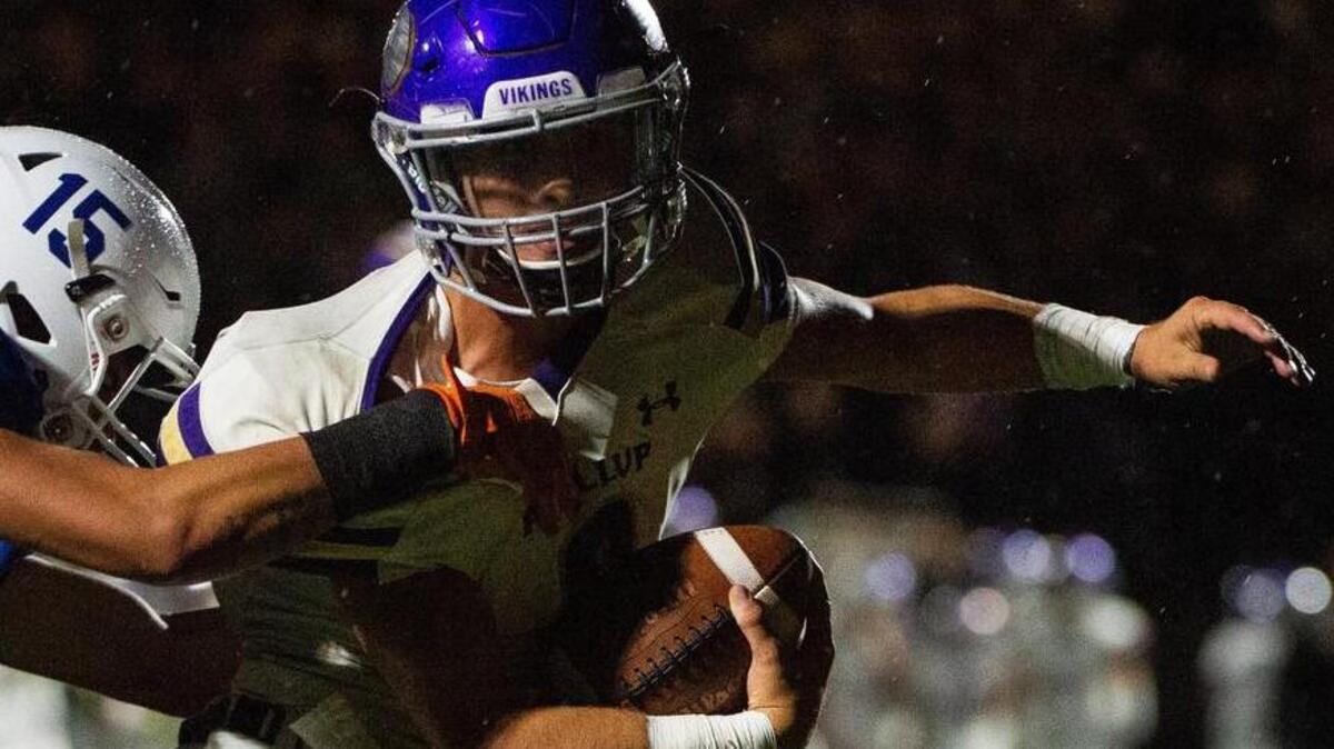 Puyallup’s Kyle Cramer (8) pulls Graham-Kapowsin’s Valentino Hansen (15) into the end zone with him during a rushing touchdown in the second quarter. Graham-Kapowsin played Puyallup in a football game at Art Crate Field in Spanaway, Wash., on Friday, Sept. 21, 2018.