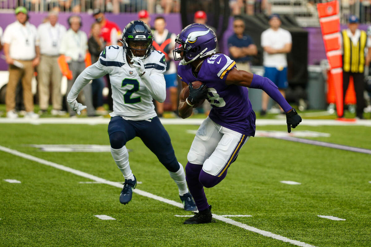 Minnesota Vikings wide receiver Justin Jefferson (18) runs past Seattle Seahawks free safety D.J. Reed (2) in the first half of an NFL football game in Minneapolis, Sunday, Sept. 26, 2021. (AP Photo/Bruce Kluckhohn)