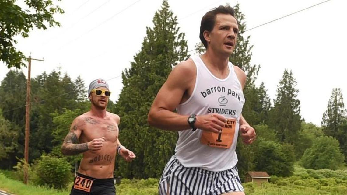 Nearing course milepost 4 along 35th Ave. eventual winner Jesse Stevick (1) of Olympia runs with Korey Konga from Lacey during the 35th Annual Capital City Marathon May 15th.