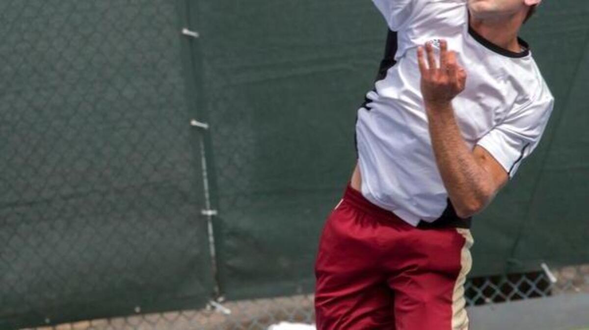 Henry Craig smashes the ball at the net against Samir Iftikhar in the men's finals of the PNW tennis tournament at Tacoma Lawn Tennis Club on Sunday, July 31, 2016.