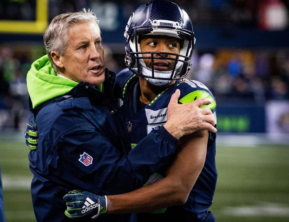 Coach Pete Carroll and wide receiver Tyler Lockett hug at the end of the Seahawks’ win over the Kansas City Chiefs last month that clinched Seattle’s sixth playoff berth in seven years. Carroll, Russell Wilson and other veterans say where the remade Seahawks are now, how bonded they are, reminds them of the 2012 team that went on to play in consecutive Super Bowls.
