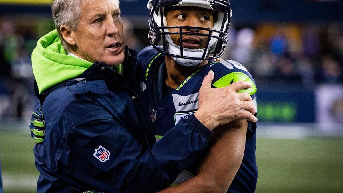 Coach Pete Carroll and wide receiver Tyler Lockett hug at the end of the Seahawks’ win over the Kansas City Chiefs last month that clinched Seattle’s sixth playoff berth in seven years. Carroll, Russell Wilson and other veterans say where the remade Seahawks are now, how bonded they are, reminds them of the 2012 team that went on to play in consecutive Super Bowls.