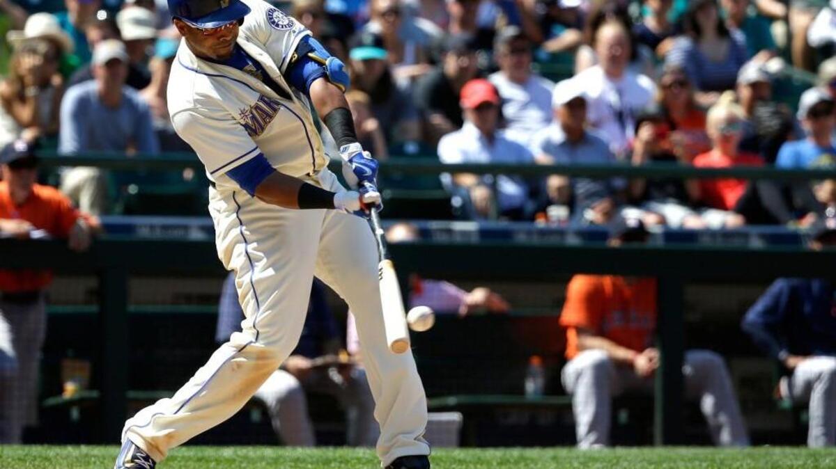 Seattle’s Nelson Cruz makes contact against Houston on Sunday. Cruz sat out of the lineup on Saturday after fouling a ball off his left foot on Friday.