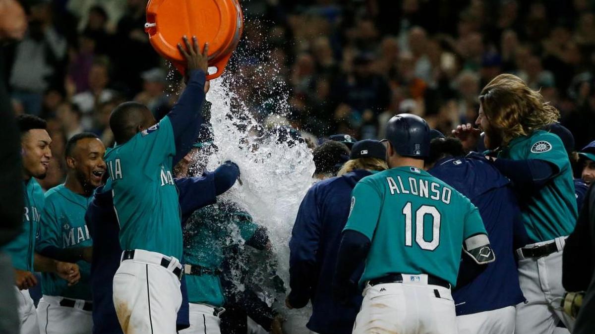 Nelson Cruz virtually disappeared under a dousing from Guillermo Heredia after hitting a walk-off homer against Cleveland.