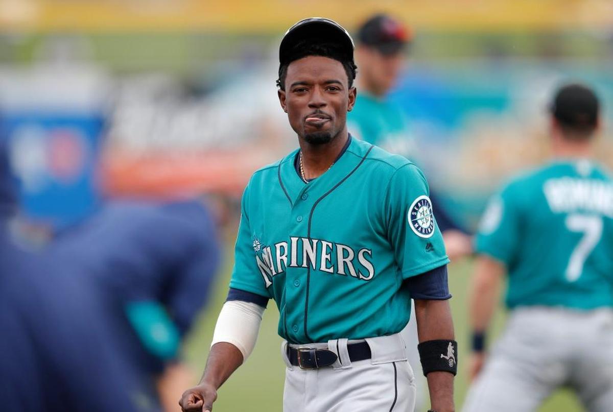 Seattle Mariners' Dee Gordon walks on the field before a spring training baseball game against the San Diego Padres,in Peoria, Ariz.