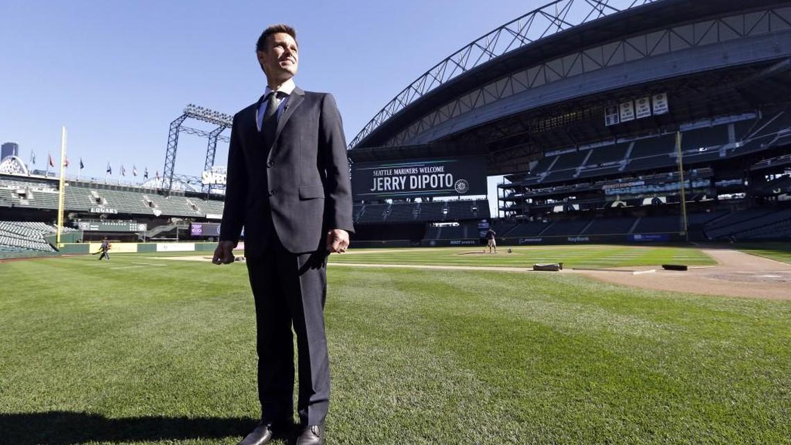
New Seattle Mariners general manager Jerry Dipoto stands on the grass at Safeco Field after a news conference Tuesday. For Dipoto, being hired by the Mariners as their new general manager comes with one task above all others: Ending the longest postseason drought in baseball. 
