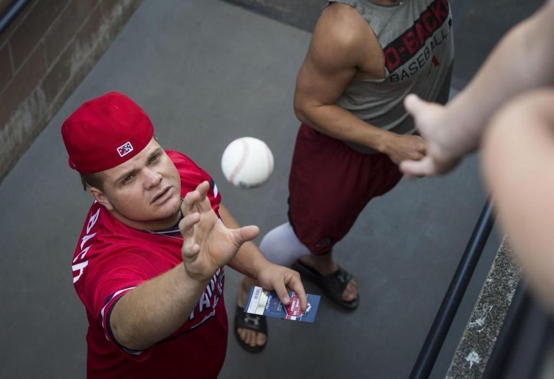 Daniel Vogelbach catches a ball from a young fan for an autograph before the Minor League Baseball Home Run Derby at Cheney Stadium in Tacoma, Wash., on Monday, July 10, 2017.