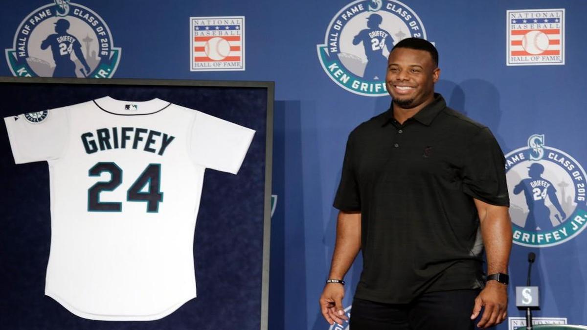 Former Seattle centerfielder Ken Griffey Jr. smiles as he stands near a jersey featuring his No. 24, which the Mariners announced will be retired in a ceremony in August.