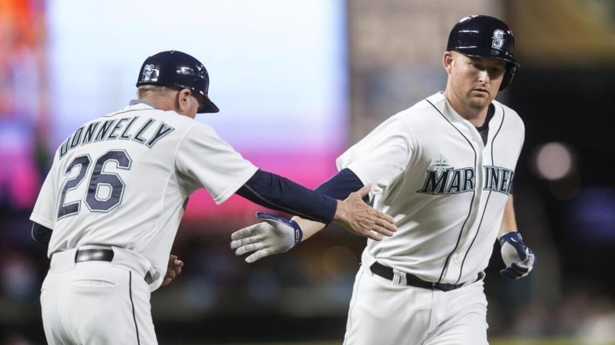 
Mark Trumbo, right, is congratulated by third base coach Rich Donnelly after a two-run home run Wednesday against the Rangers.  Trumbo went 18-for-48 in a 12-game hitting streak that ended Friday.
