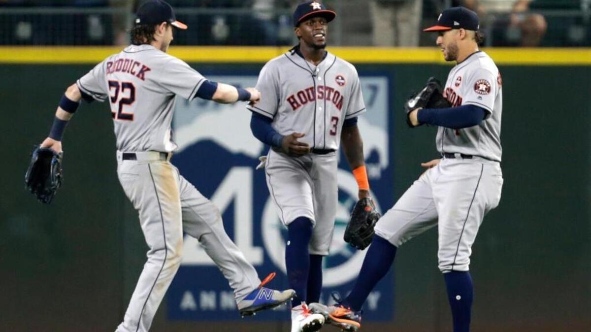 Three happy Astros after they completed a three-game sweep over the Mariners. Cameron Maybin (middle) hit a tie-breaking homer for the second straight game.