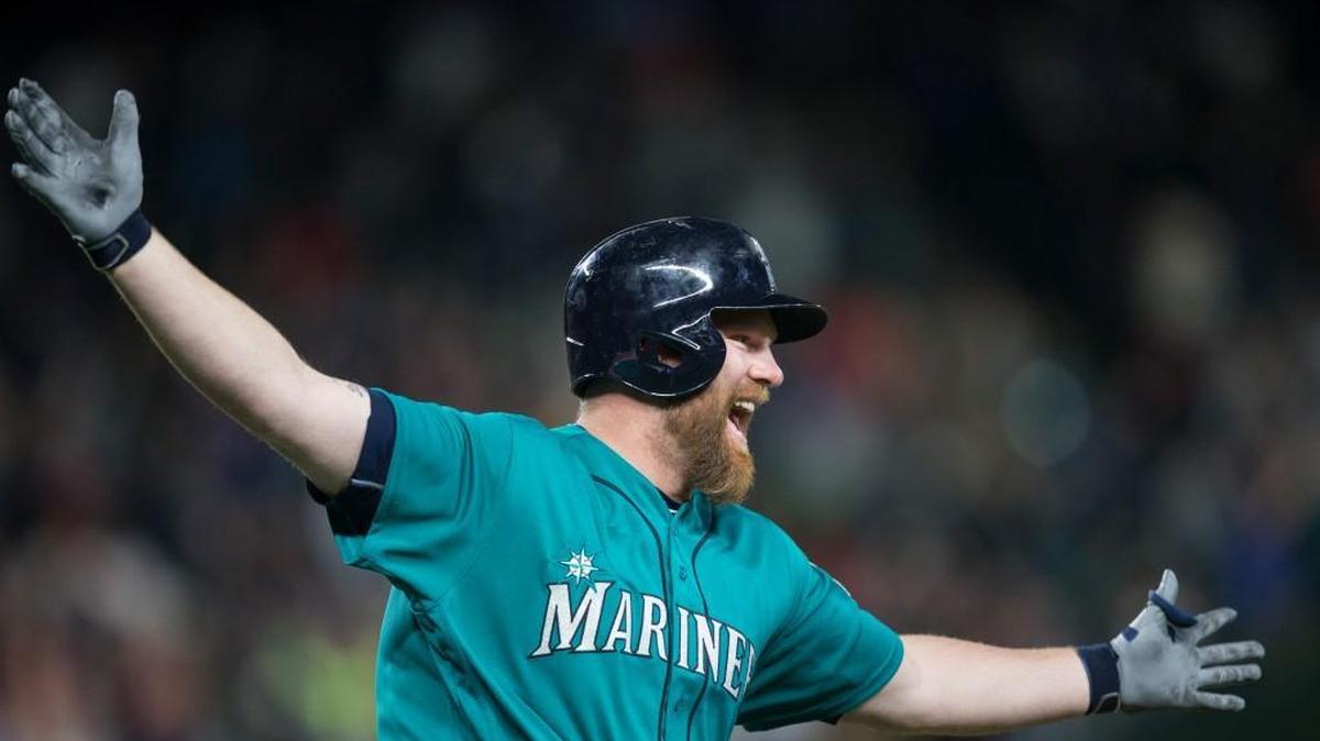 The Mariners’ Adam Lind celebrates his walk-off three-run homer run off of Cardinals reliever Trevor Rosenthal in the ninth inning Friday night at Safeco Field. Seattle trailed 3-1 when Lind came to bat.