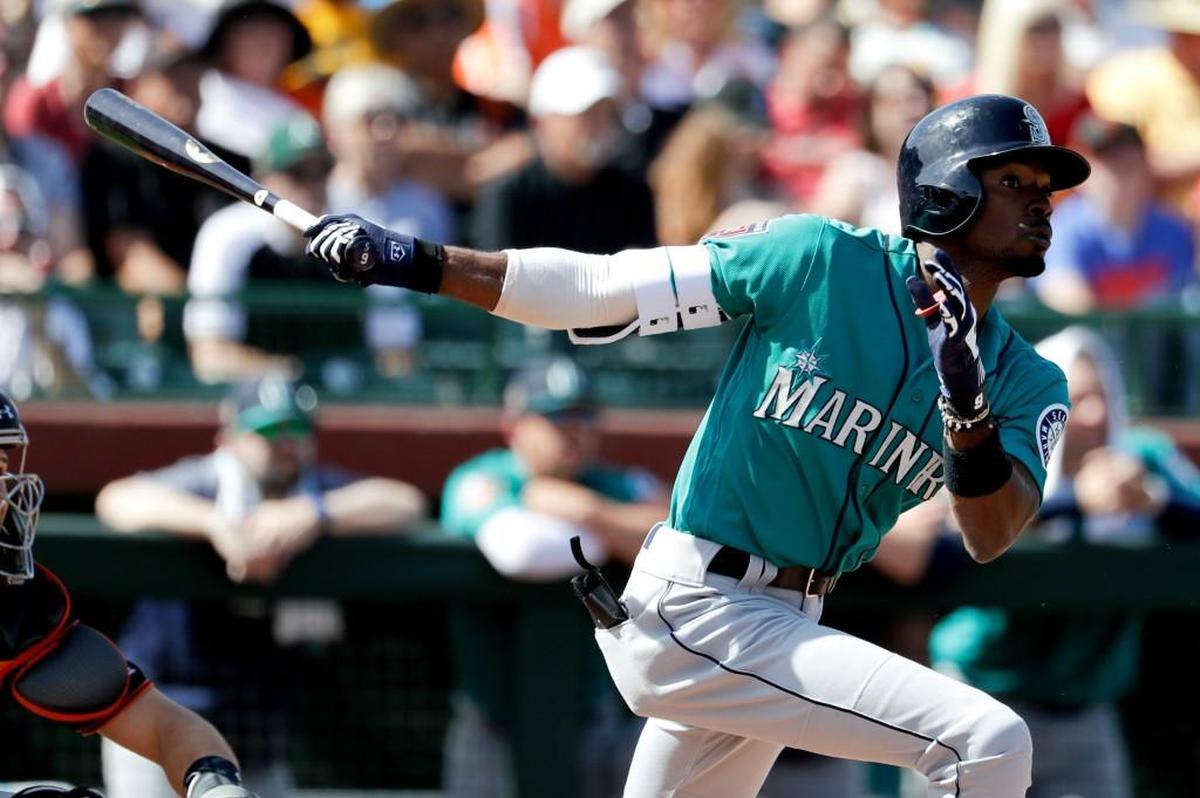 Seattle Mariners' Dee Gordon watches his two run home run against the San Francisco Giants during the third inning of a spring baseball game in Scottsdale, Ariz., Friday, March 9, 2018.
