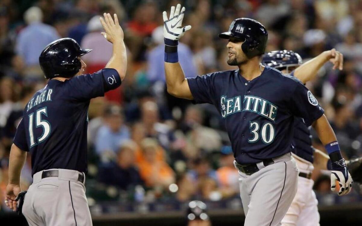 
Seattle Mariners’ Franklin Gutierrez (30) celebrates with Kyle Seager (15) after hitting a grand slam in the eighth inning Tuesday in Detroit.
