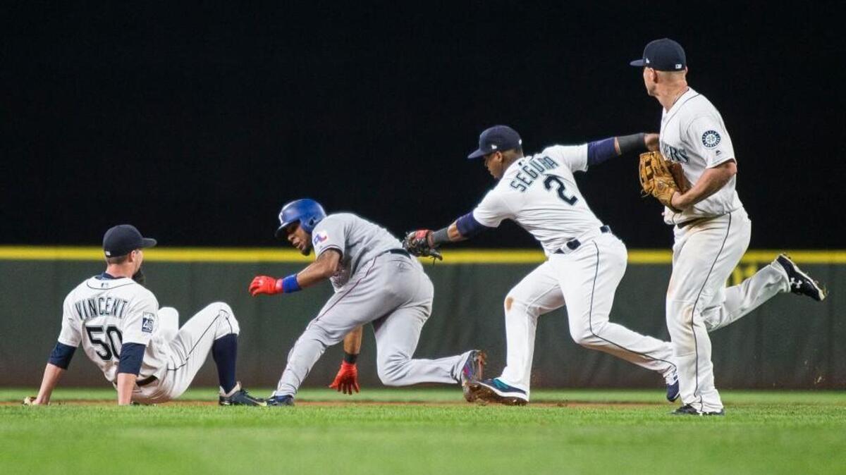 The Mariners trapped Elvis Andrus in a rundown for the second out in the eighth inning — but only after Texas scored two runs.