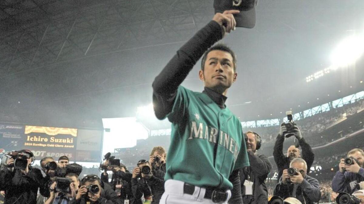 Ichiro Suzuki of the Seattle Mariners tips his hat to the crowd as he come out of the dugout to receive his tenth golden glove award before the Seattle home opener at Safeco Field on April 8, 2011.