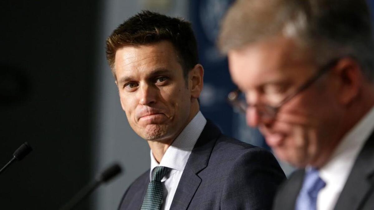 
New Seattle Mariners general manager Jerry Dipoto, left, looks on as team president Kevin Mather speaks at a news conference Tuesday, Sept. 29, 2015, in Seattle. For Dipoto, being hired by the Mariners as their new general manager comes with one task above all others: Ending the longest postseason drought in baseball.
