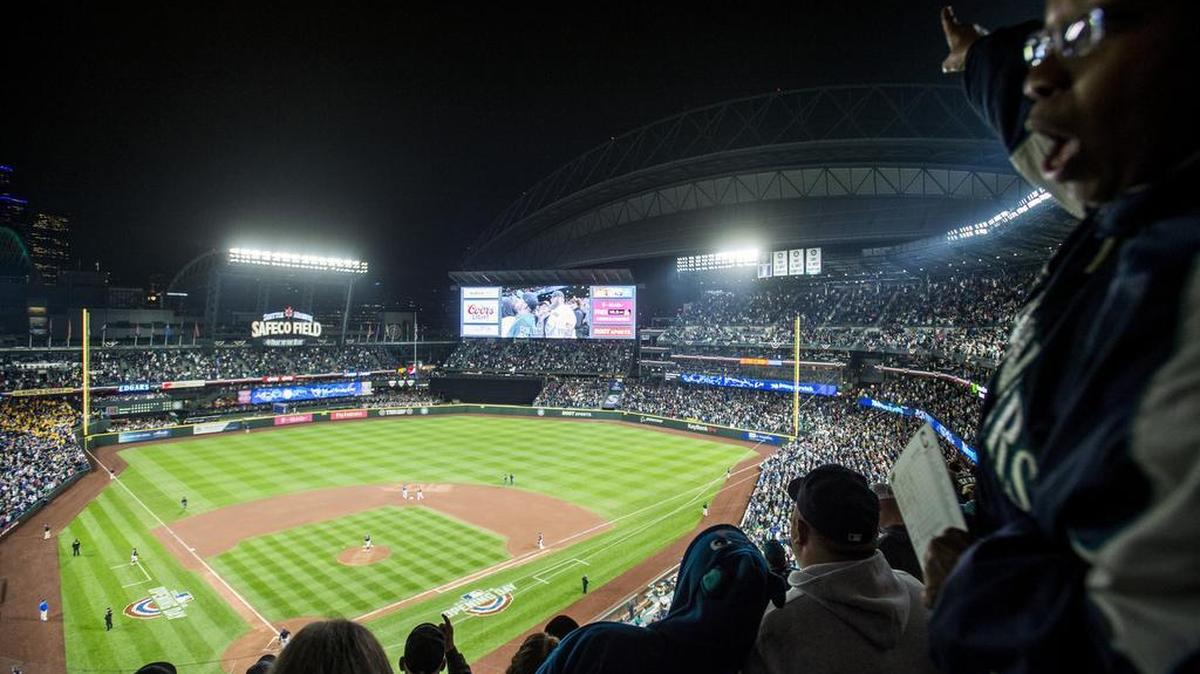 A sell-out crowd sings “Take Me Out to the Ball Game” during the seventh-inning stretch. The Seattle Mariners played the Cleveland Indians in a baseball game on Opening Day at Safeco Field in Seattle, Wash., on Thursday, March 29, 2018.