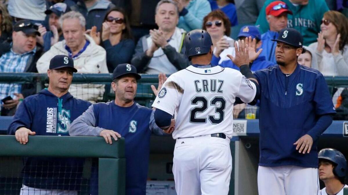 Hitting coach Edgar Martinez was among those who congratulated Nelson Cruz after a recent home run.