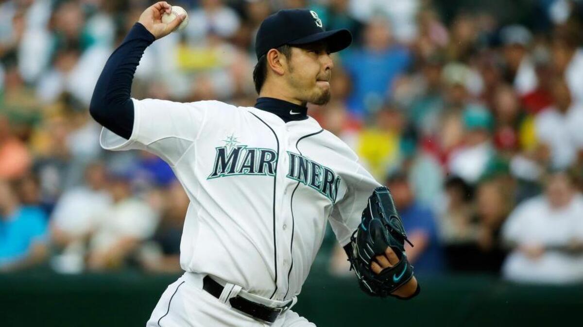 
Seattle Mariners starting pitcher Hisashi Iwakuma throws against the Oakland Athletics in the first inning Monday. Iwakuma and the Mariners allowed seven runs with two outs in the fifth inning and fell, 11-5, to last-place Oakland.
