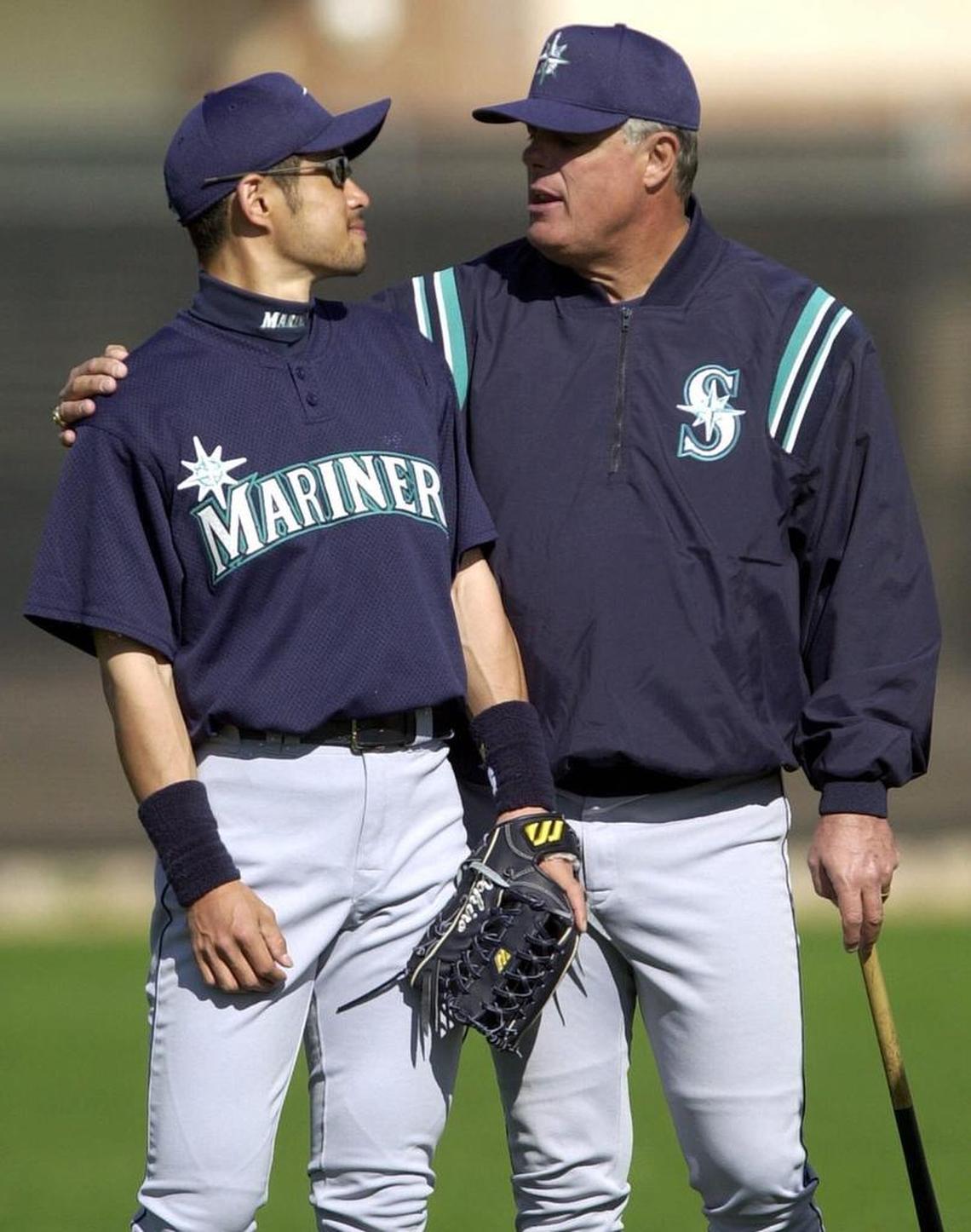 In this Feb. 21, 2001, file photo, Seattle Mariners' manager Lou Piniella puts his arm around Japanese player Ichiro Suzuki as workouts begin at their spring training campin Peoria, Ariz.