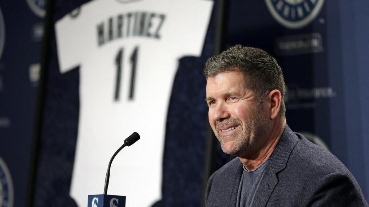 Seattle Mariners former designated hitter Edgar Martinez smiles as he speaks at a news conference announcing the retirement by the team of his jersey number 11.