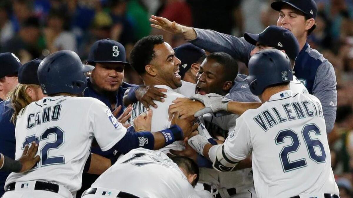 Nelson Cruz was at the center of the Mariners’ celebration after his walk-off RBI single in Saturday’s 6-5 victory over the Yankees in 10 innings.