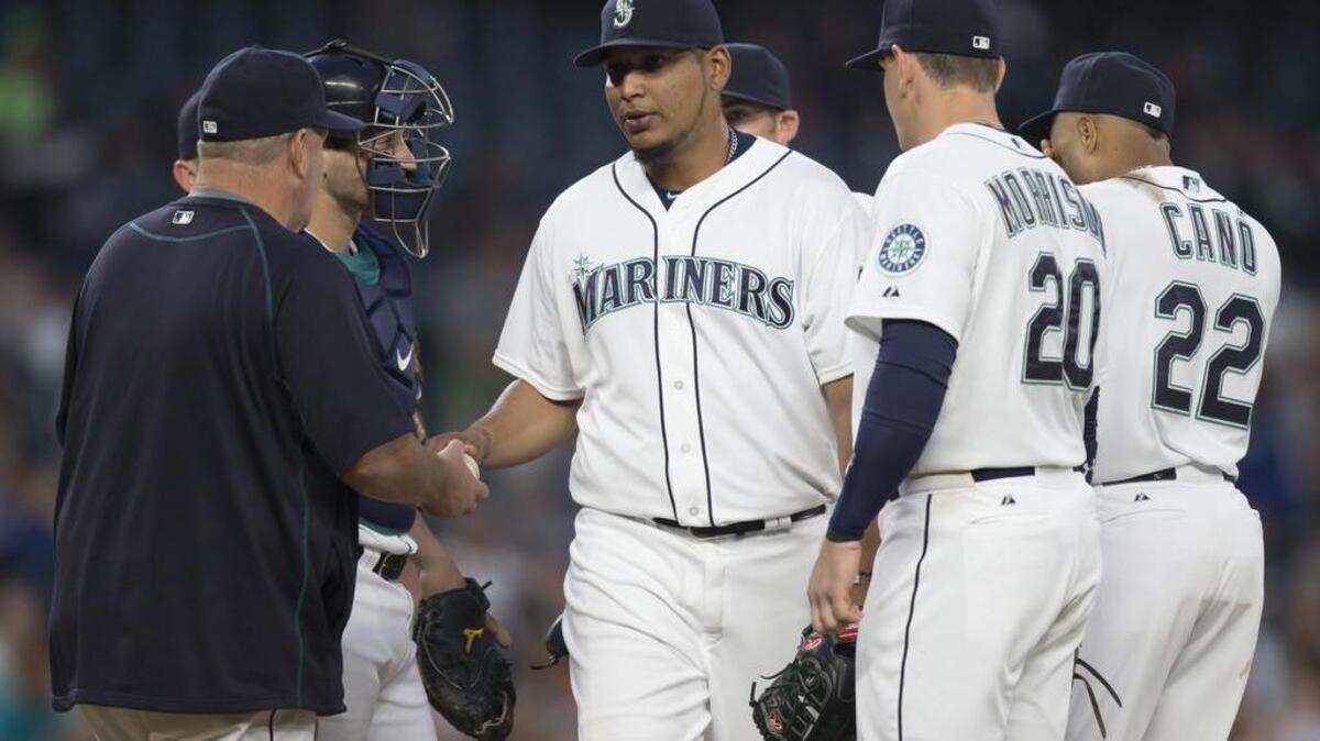 
Mariners relief pitcher Mayckol Guaipe, center, is removed from the game July 6. The Mariners recalled Guaipe, 24, from Triple-A Tacoma before Tuesday’s game against Colorado after optioning right-hander Jose Ramirez, 25, to the Rainiers.
