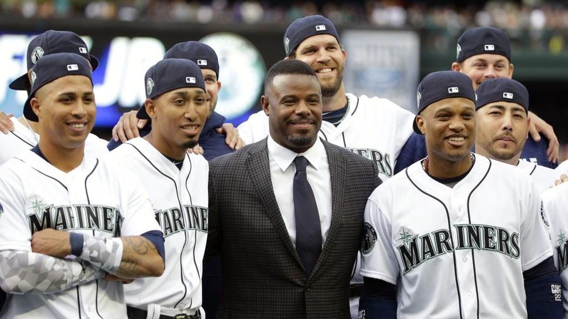 Seattle Mariners Hall of Famer Ken Griffey Jr., center, poses for a photo with current Mariners players, including Robinson Cano, lower right, following a ceremony to retire Griffey’s number 24 on Saturday in Seattle.