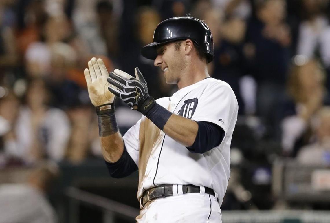 Detroit Tigers' Andrew Romine celebrates scoring on a Torii Hunter single against the San Francisco Giants in the third inning of a baseball game in Detroit Sunday, Sept. 7, 2014. (AP Photo/Paul Sancya)
