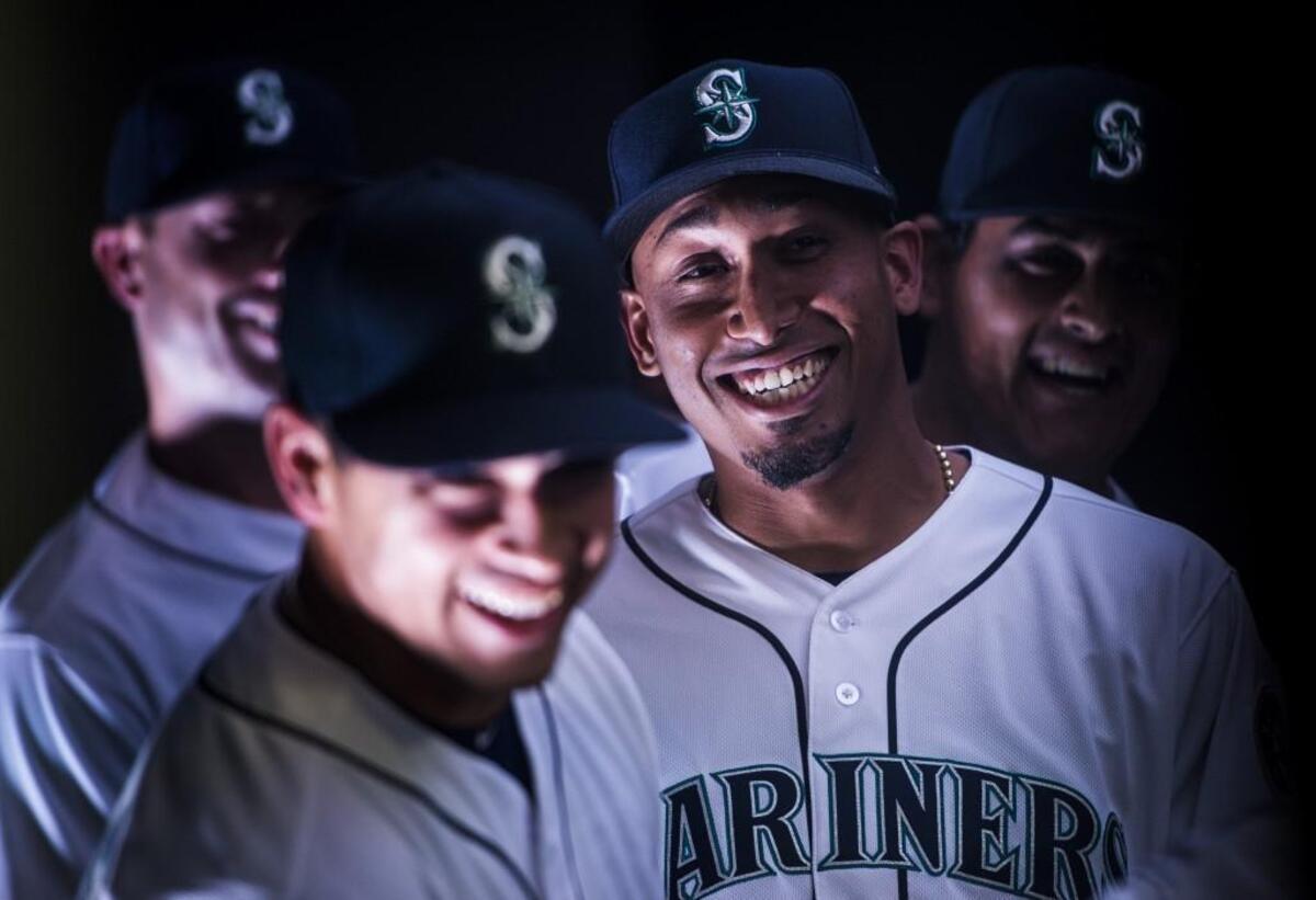 Edwin Diaz, center, shares a laugh with teammates as they wait to be introduced before the game. The Seattle Mariners played the Cleveland Indians in a baseball game on Opening Day at Safeco Field in Seattle, Wash., on Thursday, March 29, 2018.