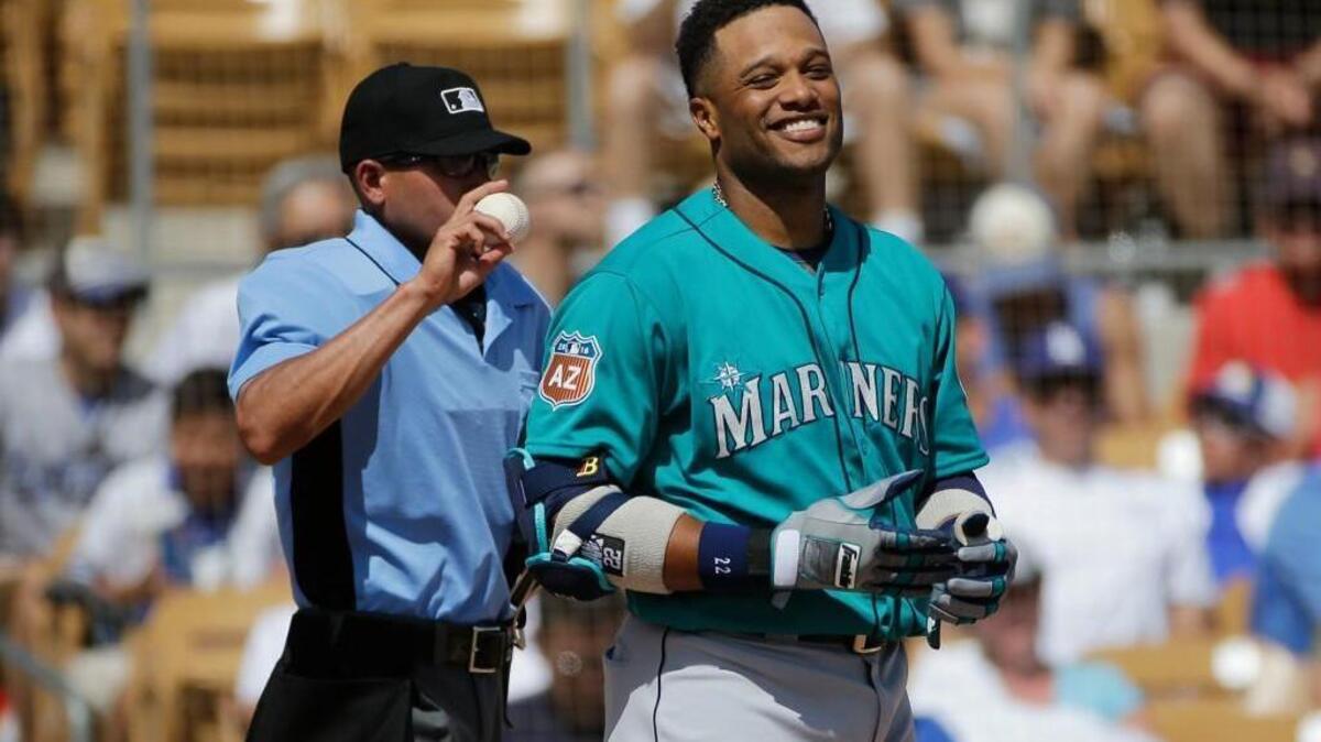 Seattle Mariners' Robinson Cano smiles after striking out during the third inning of a spring training baseball game against the Los Angeles Dodgers, Monday, March 21, 2016, in Phoenix.
