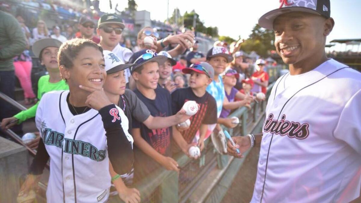 NBA point guard and Tacoma native Isaiah Thomas signs autographs at Cheney Stadium earlier this year.