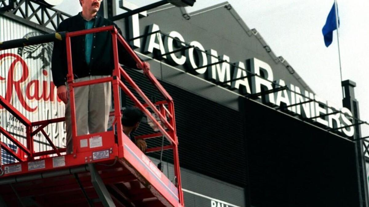 Dave Bean, pesident and general manager of the Tacoma Rainiers, gets a lift and view of Cheney Stadium next to the new scoreboard.