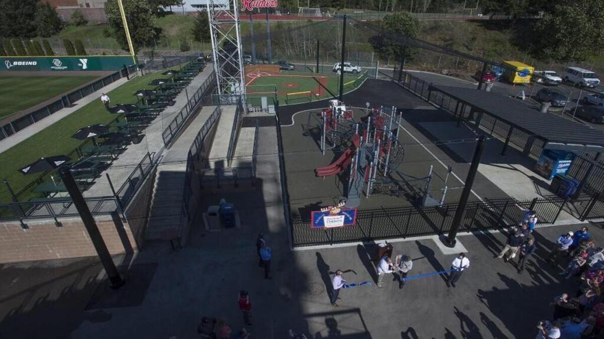 Rainiers officials and fans gather to cut the ribbon on the Mary Bridge Family Pavilion Wiffle Ball Park and Playground along the right field line Thursday 04/07/16 before the Tacoma Rainier's season opener against the Albuquerque Isotopes at Cheney Stadium.