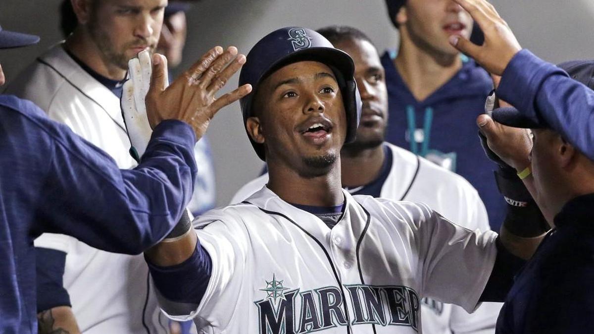 Mariners shortstop Jean Segura is congratulated after scoring against the Los Angeles Angels back in May. Segura, recovering from an ankle sprain, played in his second rehab game with the Tacoma Rainiers on Tuesday.