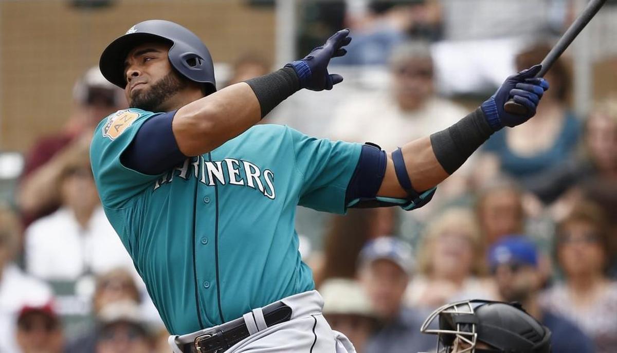 Seattle Mariners' Nelson Cruz swings on a pitch against the Colorado Rockies during the second inning of a spring training baseball game Saturday, April 1, 2017, in Scottsdale, Ariz.