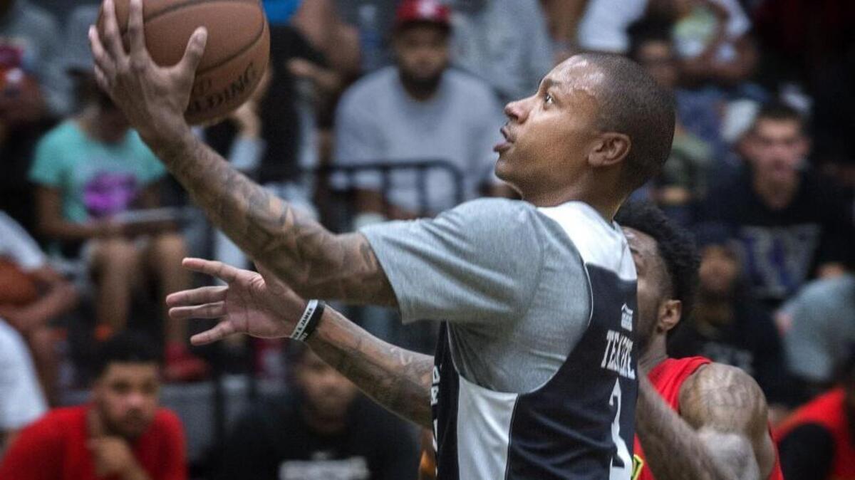 Boston Celtics player Isaiah Thomas goes up for a layup playing against players at Foss High School on Monday. Thomas, who attended Curtis High School, hosted a three-day tournament at Foss High with about 12 NBA players at the event.