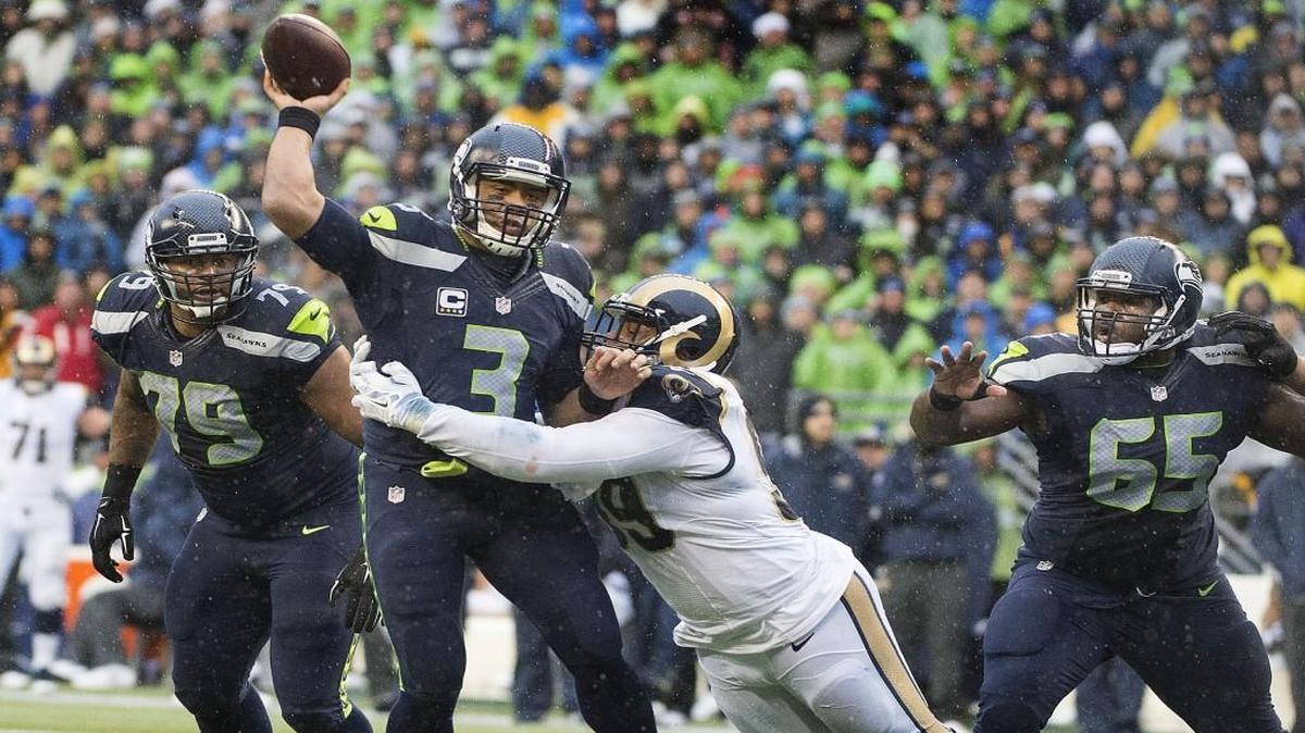 Seattle quarterback Russell Wilson is nearly sacked by Rams tackle Aaron Donald in the first half. Photo taken in Seattle on Sunday, Dec. 27, 2015.