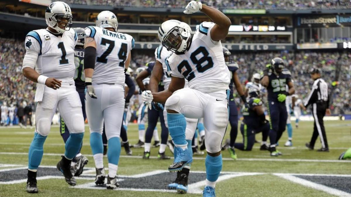 Carolina’s Jonathan Stewart (28) celebrates after scoring a touchdown against Seattle on Oct. 18 in the second half as Panthers quarterback Cam Newton (1) looks on. The ex-Timberline High School star rushed for 78 yards and two touchdowns.