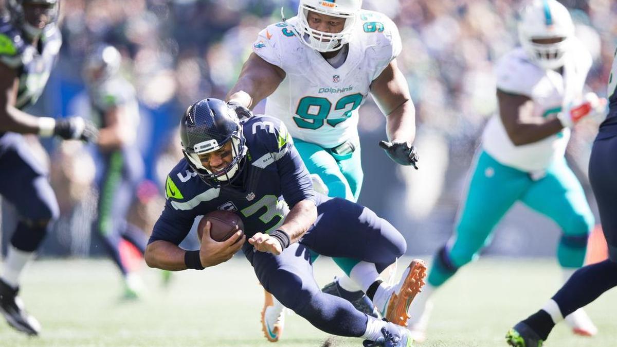 Ndamukong Suh (93) of the Dolphins steps on Russell Wilson’s ankle last weekend. Wilson had a wrap around both ankles at a Seahawks practice Wednesday. Offensive coordinator Darrell Bevell says he expects Wilson to be a “full go” for Sunday’s game against the Rams.
