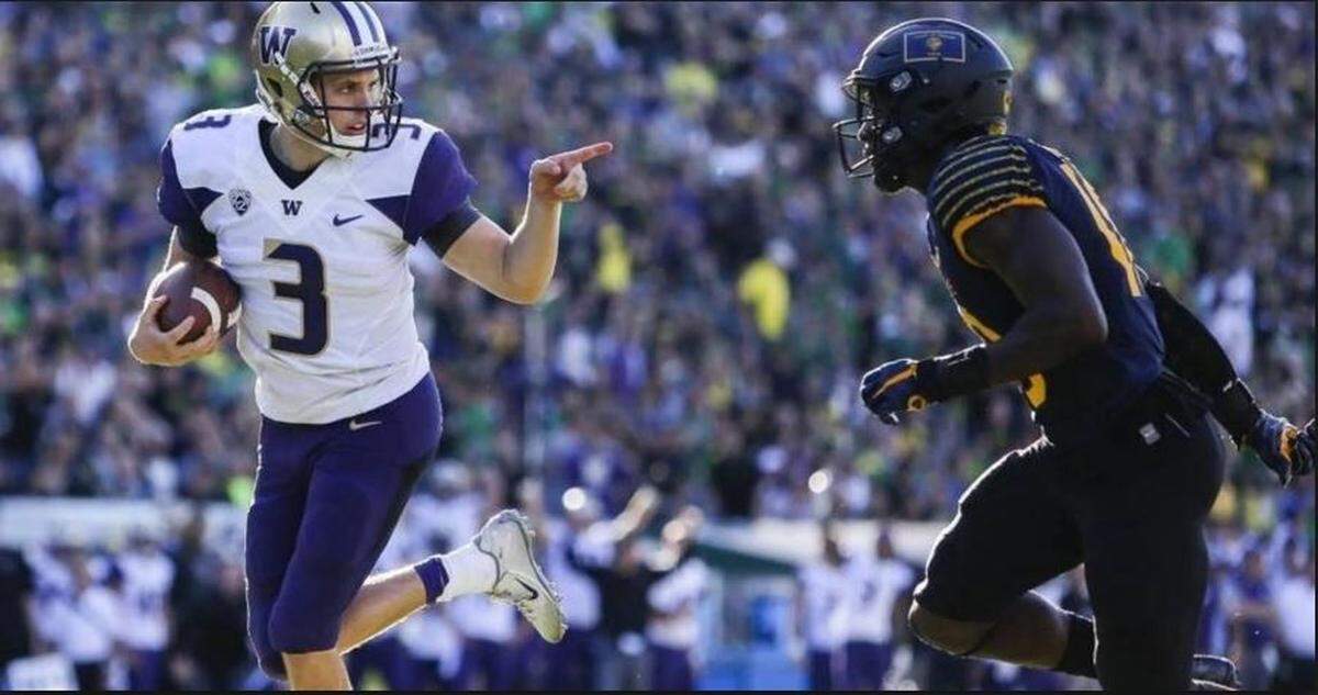 Washington quarterback Jake Browning points at an Oregon defender on his way to the end zone in the Huskies’ 70-21 runaway from the Ducks in Eugene in October 2016.