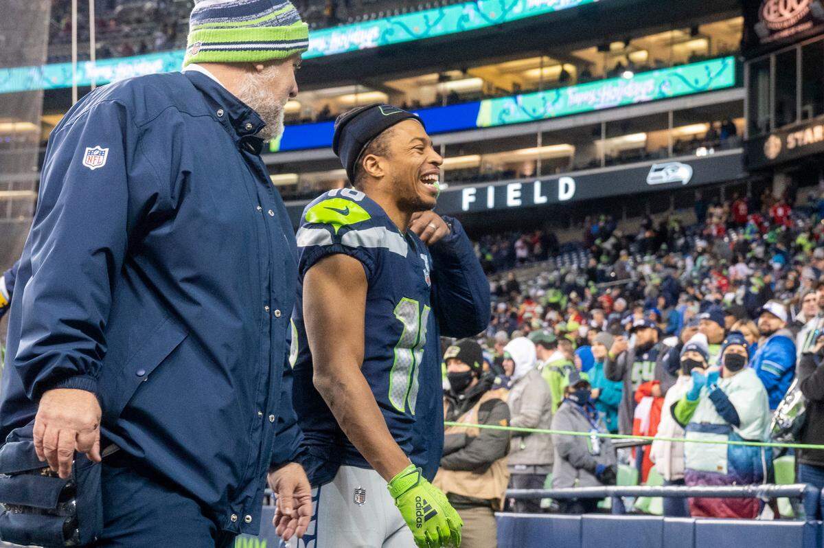 Seattle wide receiver Tyler Lockett (16) walks off the field after helping the Seahawks to a 30-23 win over the San Francisco 49ers on Sunday at Lumen Field in Seattle.