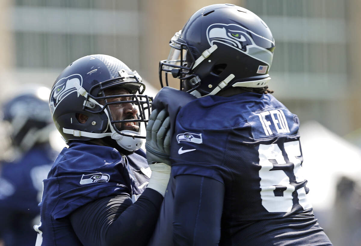 Germain Ifedi (65) works with fellow tackle George Fant, left, during Seahawks training camp this month. Friday in the preseason game at Minnesota, those two will be competing for the starting job at right tackle.