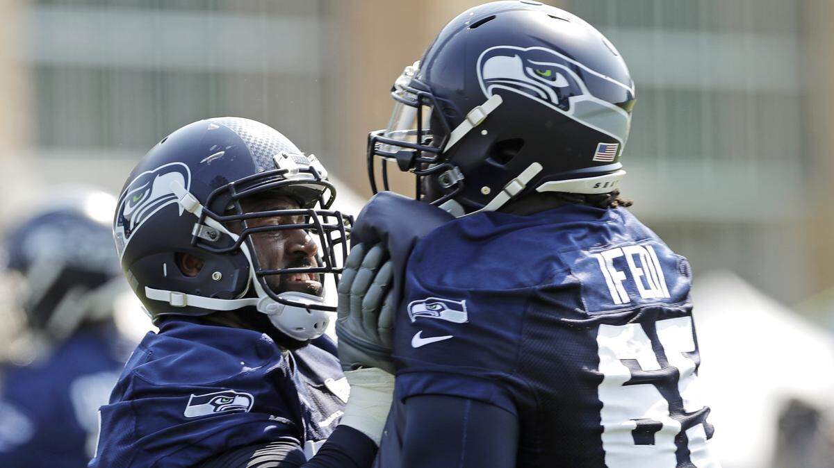 Germain Ifedi (65) works with fellow tackle George Fant, left, during Seahawks training camp this month. Friday in the preseason game at Minnesota, those two will be competing for the starting job at right tackle.
