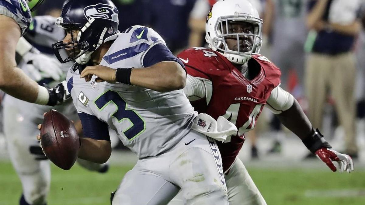Seattle Seahawks quarterback Russell Wilson (3) scrambles away from the reach of Arizona Cardinals outside linebacker Markus Golden (44) during the second half of Sunday’s game in Glendale, Ariz.
