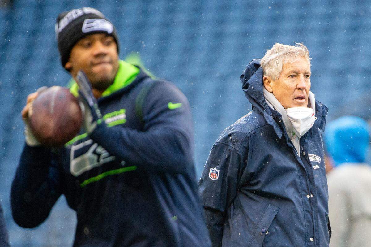 Seattle Seahawks head coach Pete Carroll looks on as quarterback Russell Wilson (3) winds up to throw a pass during warm ups prior to the start of the Seattle’s game against the Detroit Lions on Sunday, Jan. 2, 2022, at Lumen Field.