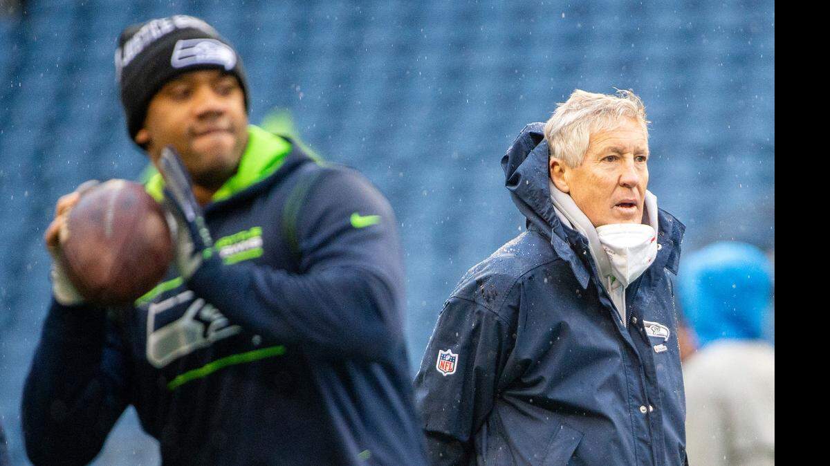 Seattle Seahawks head coach Pete Carroll looks on as quarterback Russell Wilson (3) winds up to throw a pass during warm ups prior to the start of the Seattle’s game against the Detroit Lions on Sunday, Jan. 2, 2022, at Lumen Field.