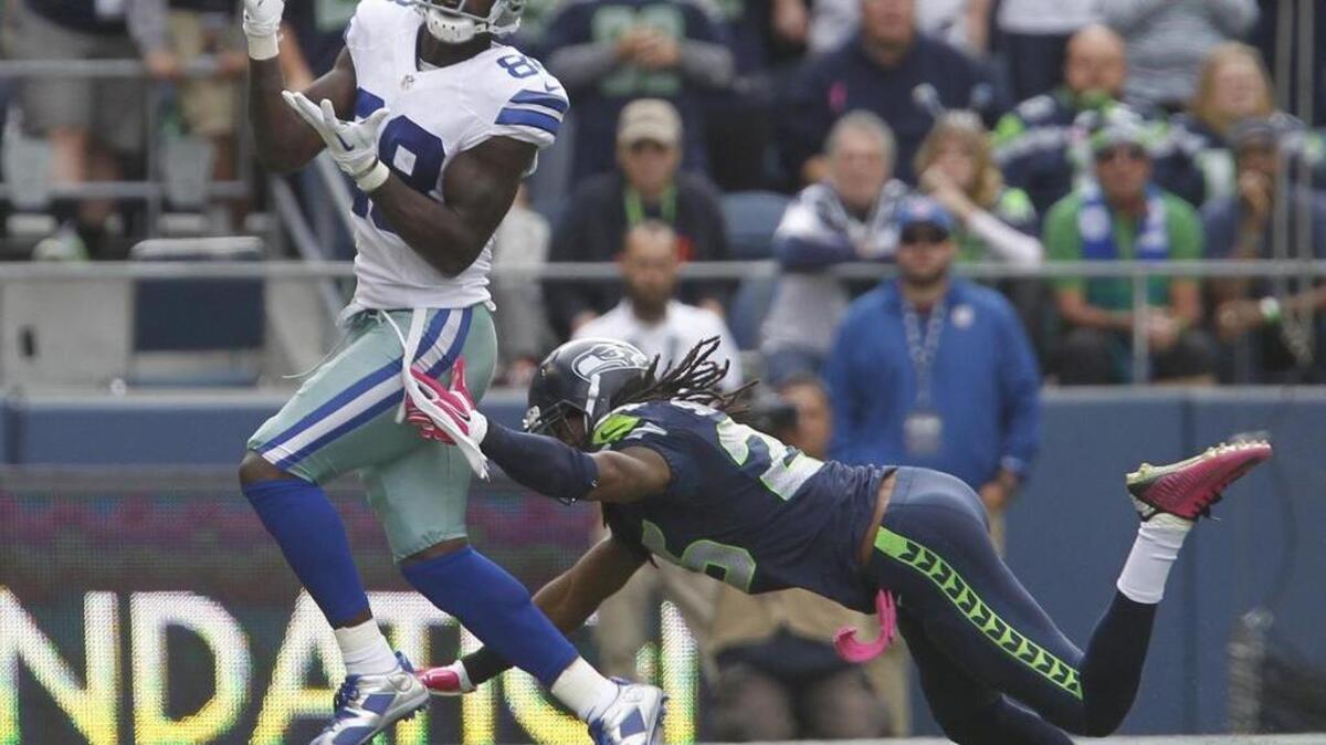 Dallas wide receiver Dez Bryant pulls in a pass over Seattle corner Richard Sherman last season at CenturyLink Field. Sherman held Bryant to just two catches then, and may have to do the same Sunday.